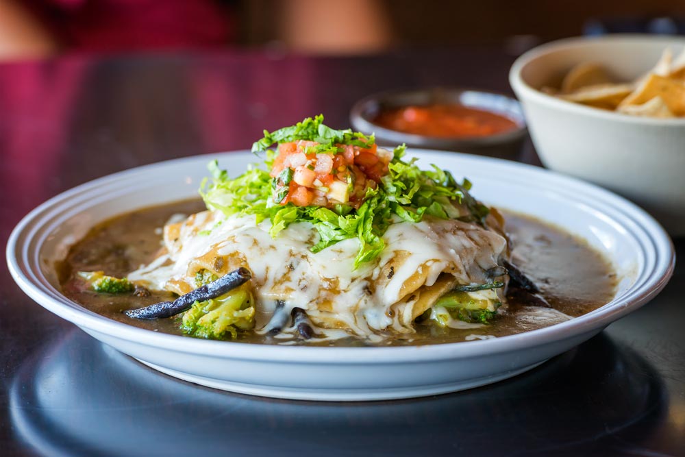 Veggie Stacked Enchilada with long beans and sweet potato greens. Daniel Lane photo