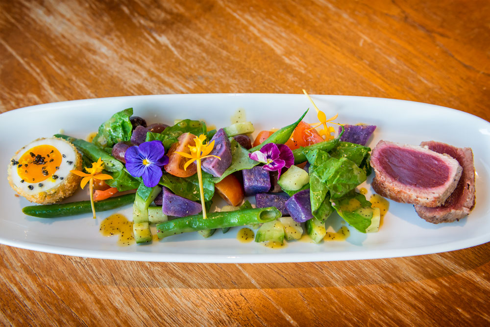 Coast Grille Nicoise ($17 with a deep-fried egg, Molokai black salt, seared ahi, Molokai sweet potatoes, cucumber, green beans, Kalamata olives. Daniel Lane photo