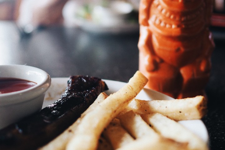 French fries and tropical drink at restaurant on Kauai, Hawaii