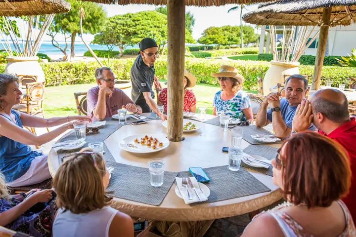 Food tour participants enjoying a meal on Kauai, Hawaii