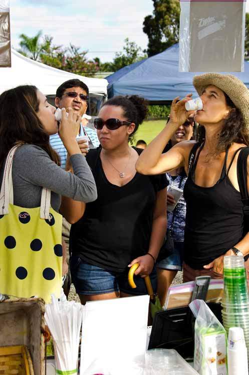 Visitors of the Hanalei Farmers Market enjoying beverages