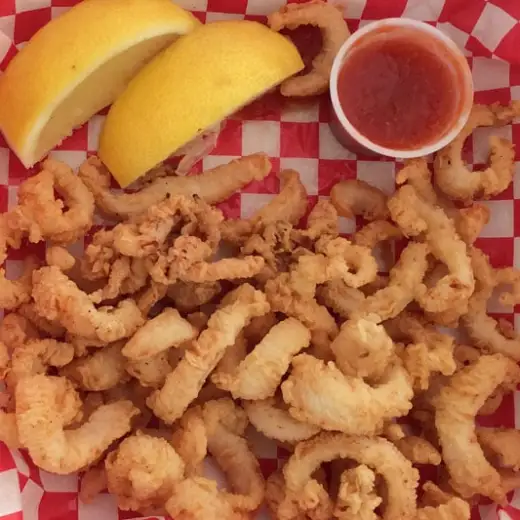 a close up of a plate of hot dogs and fries